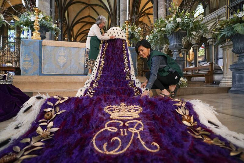 Linda Bainbridge and Miyuki Griffin put finishing touches to The Crown, Orb and Sceptre exhibit as part of 'A Festival of Flowers' at Salisbury Cathedral.  PA