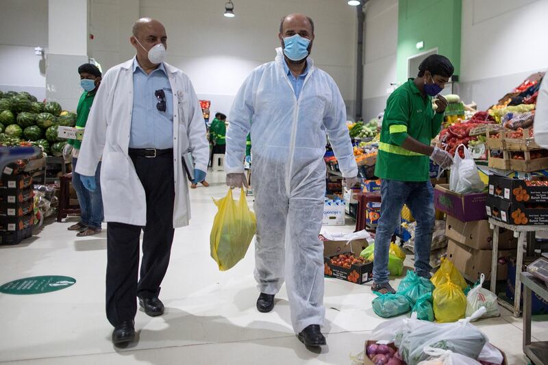 Customers wearing protective masks as they shop at the vegetables market for the upcoming Ramadan in Dubai.  EPA