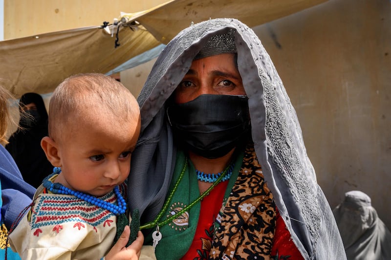 Farzana, who fled her village in Helmand when it was overrun by the Taliban, waits with her baby to see a doctor.