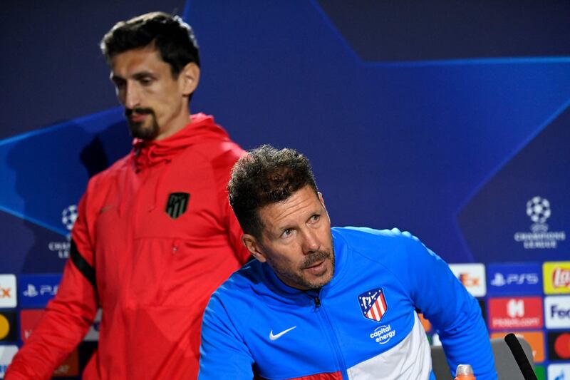 Atletico Madrid defender Stefan Savic and coach Diego Simeone arrive at a press conference in Madrid. AFP