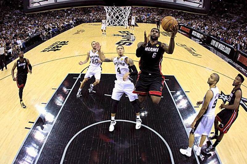 Miami Heat LeBron James (6) scores past San Antonio Spurs Danny Green (4) in the first half during Game 4 of their NBA Finals basketball series in San Antonio, Texas June 13, 2013.  REUTERS/Lucy Nicholson (UNITED STATES  - Tags: SPORT BASKETBALL)  