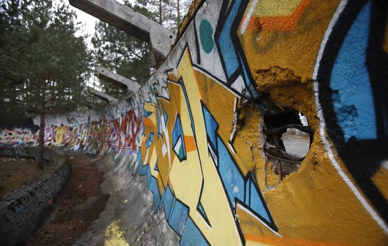 In this picture taken on February 21, 2014, the bobsleigh track damaged by artillery fire is painted with graffiti at Mt. Trebevic near Bosnian capital of Sarajevo. Wartime destruction and negligence have turned most of Sarajevo’s 1984 Winter Olympic venues into painful reminders of the city’s golden times. The world came together in the former Yugoslavia in 1984 after the West had boycotted the 1980 Olympics in Moscow and Russia boycotted the 1984 Summer Games in Los Angeles. Just eight years later, the bobsleigh and luge track on Mount Trbevic was turned into an artillery position from which Bosnian Serbs pounded the city for almost four years. Today, the abandoned concrete construction looks like a skeleton littered with graffiti. Amel Emric / AP Photo