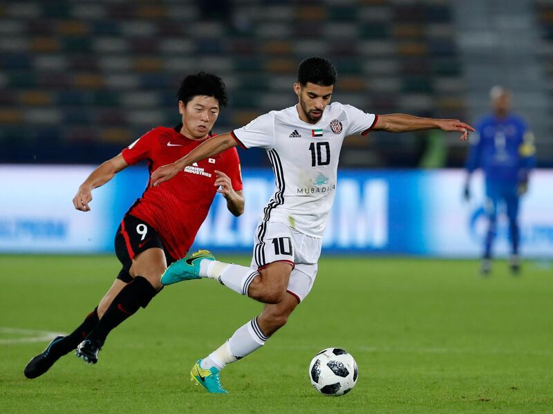 Japan's Urawa Reds Yuki Muto, left, challenges for the ball with Al Jazira's Mark Boussoufa during the Club World Cup soccer match between Al Jazira Club and Urawa Reds at Zayed sport city in Abu Dhabi, United Arab Emirates, Saturday, Dec. 9, 2017. (AP Photo/Hassan Ammar)