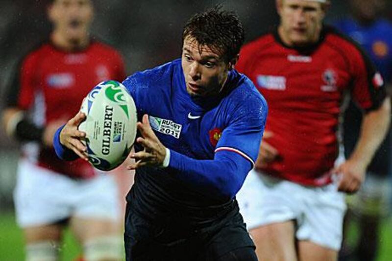 Vicent Clerc makes sure he has control of the ball in slippery conditions during France's 46-19 win against Canada.