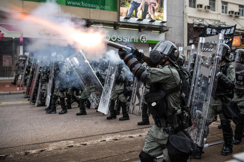 HONG KONG, CHINA - JULY 27: Riot police fire tear gas towards protesters in the district of Yuen Long on July 27, 2019 in Hong Kong, China. Pro-democracy protesters have continued weekly rallies on the streets of Hong Kong against a controversial extradition bill since 9 June as the city plunged into crisis after waves of demonstrations and several violent clashes. Hong Kong's Chief Executive Carrie Lam apologized for introducing the bill and recently declared it "dead", however protesters have continued to draw large crowds with demands for Lam's resignation and completely withdraw the bill. (Photo by Laurel Chor/Getty Images)