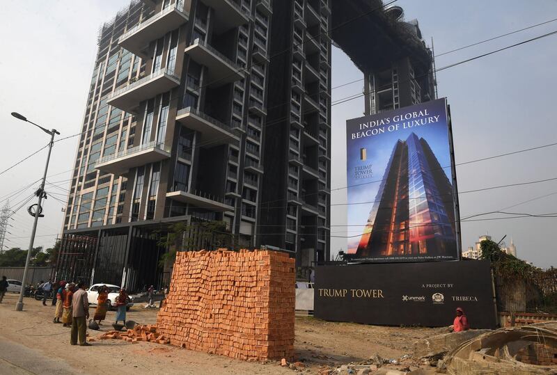 Indian labourers work on the road leading to the under-construction Trump Tower in Kolkata. Dibyangshu Sarkar / AFP