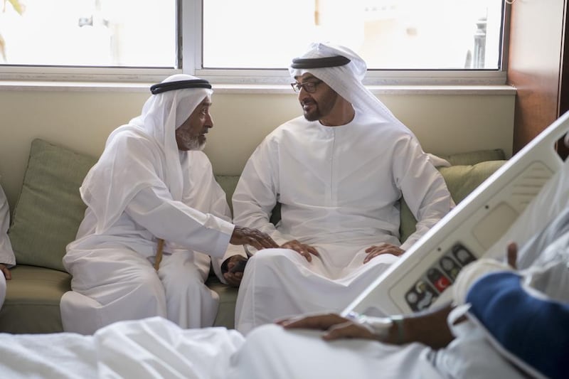 Sheikh Mohammed bin Zayed, Crown Prince of Abu Dhabi and Deputy Supreme Commander of the Armed Forces, speaks with a guest during a visit to Fadhel Ahmed Al Meheiri (not shown) who was injured while serving in Yemen, at Zayed Military Hospital. Hamad Al Kaabi / Crown Prince Court — Abu Dhabi