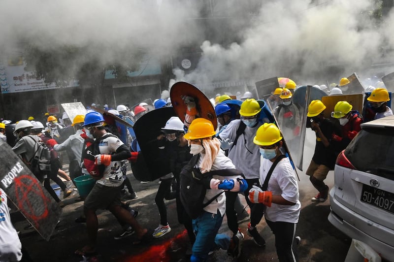 Protesters use homemade shields to protect themselves during a demonstration in Yangon. AFP