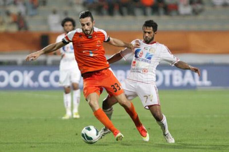 Dubai, United Arab Emirates, May 14, 2013 -   Driss Fettouhi (left) from Ajman fight for the ball with Sulthan Saleh Berghush from Al Jazira, during the Pro League Etisalat Cup final at Al Wasl's Zabeel Stadium. ( Jaime Puebla / The National Newspaper ) 