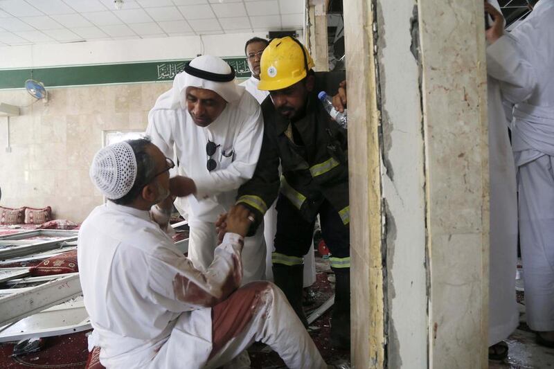 A man wounded in a suicide attack on the Shiite Imam Ali mosque during Friday prayers in eastern Saudi Arabia, is attended to by civil defence and medics. EPA