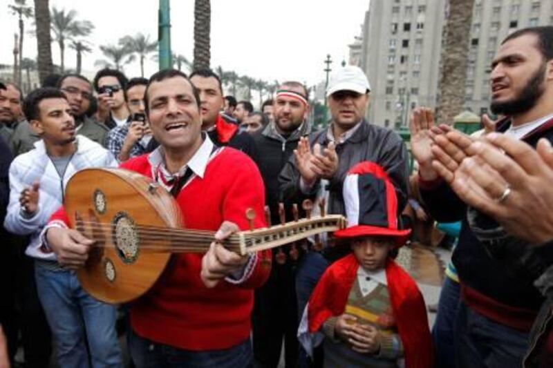 A musician performs during a demonstration in Tahrir Square, Cairo, Egypt, Monday, Feb. 7, 2011. The protests, which saw tens of thousands of people massing daily in downtown Cairo for demonstrations that at times turned violent, have raised questions about the impact on the economy. More than 160,000 foreign tourists fled the country in a matter of days last week, in an exodus sure to hammer the vital tourism sector. (AP Photo/Manoocher Deghati) *** Local Caption ***  BCO119_Mideast_Egypt.jpg