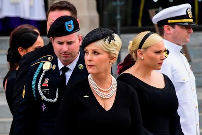 (FILES) In this file photo taken on September 01, 2018 Cindy McCain (C) the widow of US Senator John McCain and her sons and daughters look on after a Military Honor Guard placed the casket of US Senator John McCain into a hearse at the end of his memorial service for  at the Washington National Cathedral in Washington, DC. In a series of tweets Cindy McCain, the wife of the late Sen. John McCain, announced her endorsement of Democratic nominee Joe Biden for president on late September 22, 2020. / AFP / JIM WATSON 
