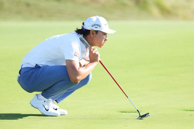 Min Woo Lee lines up a putt on the 12th green. Getty