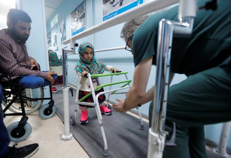 Maya Merhi practises walking with her new artificial legs at a prosthetic centre in Istanbul, Turkey, on July 5, 2018. Reuters