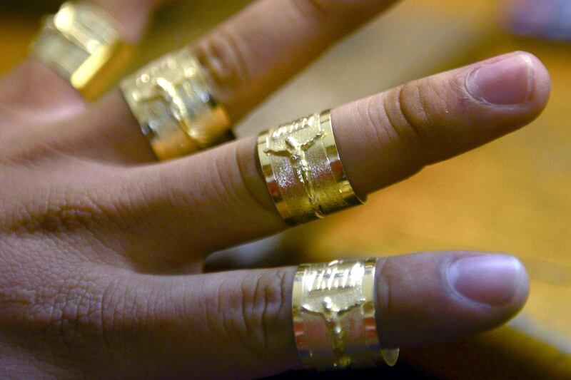 The price of the gold troy ounce currently stands at just below US$1,300. Above, a craftsman shows gold rings in Antioquia, Colombia. Raul Arboleda / AFP