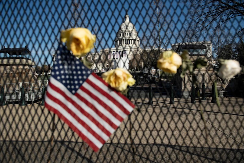 Flowers on a fence, a week after a pro-Trump mob broke into and took over the Capitol, in memory of slain Capitol Police Officer Brian Sicknick, in Washington, January 14, 2021. AFP