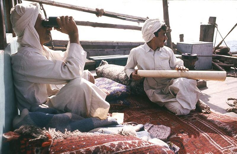 Nakhoda father and son look out to sea.