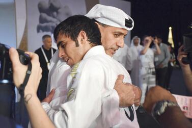 Omar Al Fadhli is congratulated UAEJJF chairman Abdulmunam Al Hashemi after completing a double at the JJIF World Championship in Abu Dhabi on Saturday. Courtesy Shivanna Gowda