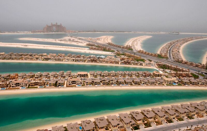 Villas are seen on The Palm, Jumeirah, with Atlantis, The Palm, currently under construction, on the breakwater (surrounding crescent) in Dubai May 3, 2008. Once filled with the cacophony of cranes and construction labourers, Dubai today hums to the work of a quieter crowd. The brash Gulf emirate, renowned for extravagant real estate projects and flashy living, has turned into a city of auditors. Picture taken May 3, 2008. To match Special Report DUBAI/     REUTERS/Jumanah El Heloueh/Files (UNITED ARAB EMIRATES  - Tags: BUSINESS ENVIRONMENT SOCIETY TRAVEL)