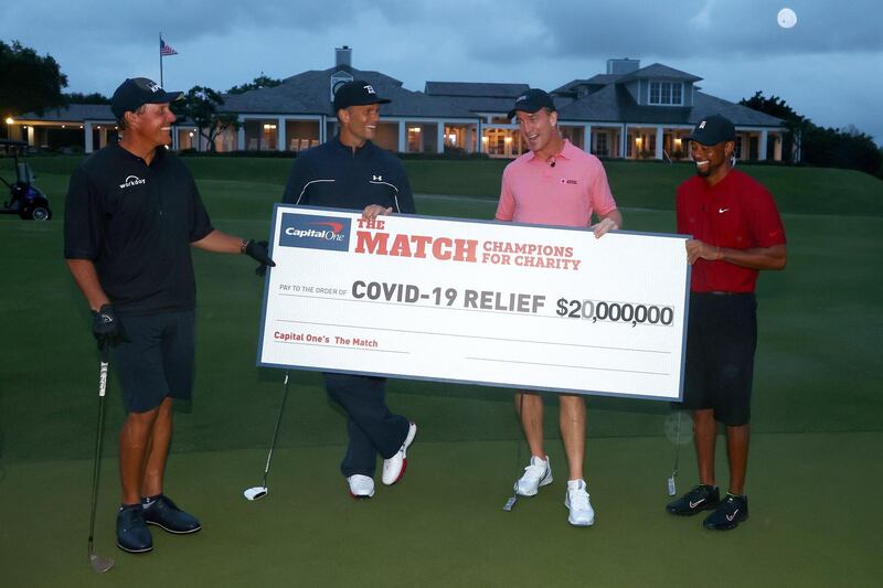 Tiger Woods and Peyton Manning celebrate their win over  Phil Mickelson and Tom Brady. EPA