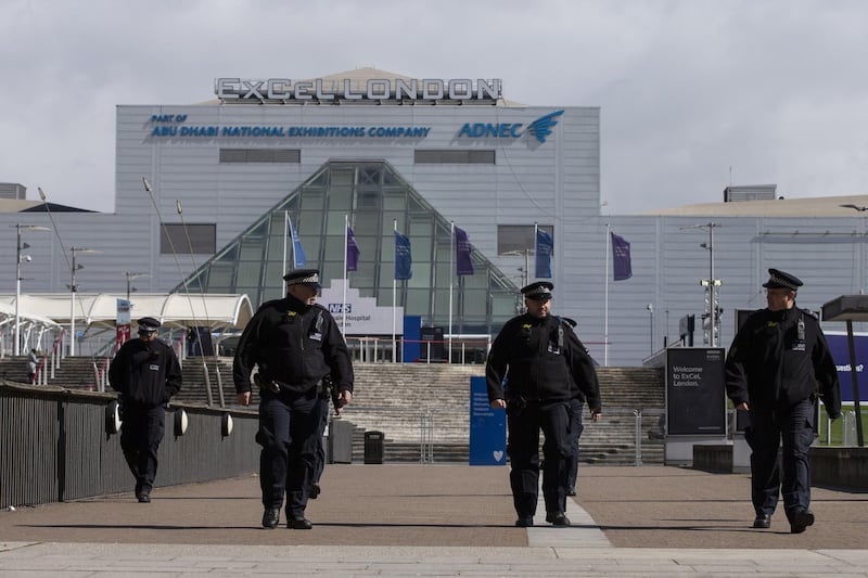 Metropolitan Police officers stand outside the new NHS Nightingale Hospital at ExCeL London. Courtesy Getty Images