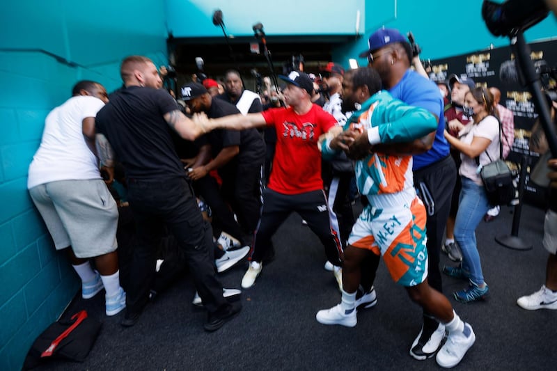 Floyd Mayweather is held back by security after a scuffle with Jake Paul. AFP