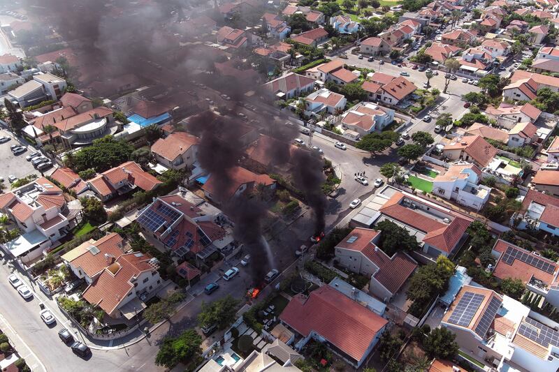 An aerial view shows vehicles on fire as rockets are launched from the Gaza Strip, in Ashkelon, southern Israel. Reuters