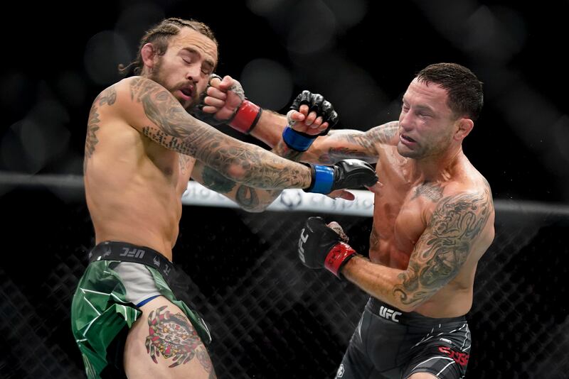 Marlon Vera, left, and Frankie Edgar exchange punches. AP Photo