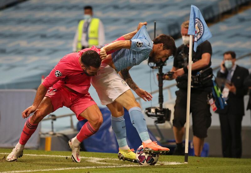 Real Madrid's Dani Carvajal, left, pulls the shirt of Manchester City's David Silva. AP