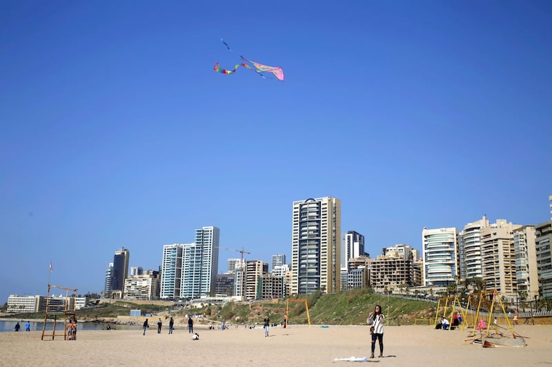 A girl flies a kite at the public beach of Ramlet al-Baida in in Beirut, Lebanon, Sunday, Feb. 26, 2017. (AP Photo/Hassan Ammar)