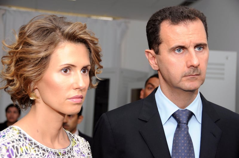 FILE - In this July, 13, 2010 file photo, Syrian President Bashar Assad, left, and his wife Asma Assad, listen to explanations as they visit a technology plant in Tunis, Tunisia. Assadâ€™s office said Wednesday, March 17, 2021, the country's first couple are on their way to recovery nine days after they tested positive for coronavirus. The presidency said that Assad and his wife have had mild symptoms of the illness and are continuing their work as usual from home and will return to normal life once they test negative to COVID-19 (AP Photo/Hassene Dridi, File)