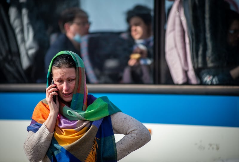A Ukrainian woman makes a phone call after crossing the Slovakian border. AFP