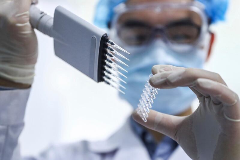 In this April 11, 2020 photo, released by Xinhua News Agency, a staff member tests samples of a potential COVID-19 vaccine at a production plant of SinoPharm in Beijing. In the global race to make a coronavirus vaccine, the state-owned Chinese company is boasting that it gave its employees, including top executives, experimental shots even before the government OK'd testing in people. (Zhang Yuwei/Xinhua via AP)