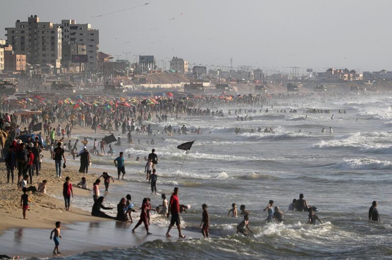 Palestinians crowds the beach at sunset in Gaza, people are preparing to celebrate Eid Al Adha without coronavirus restrictions imposed elsewhere in the Middle East. Reuters