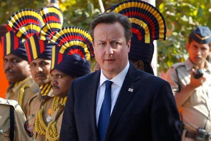David Cameron, the British prime minister, pays tribute at the Police Memorial in Mumbai on Monday during the first day of a three-day visit. Rajanish Kakade / AP Photo