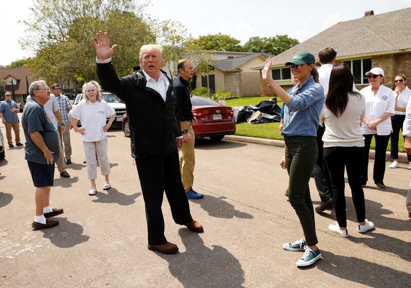U.S. President Donald Trump and first lady Melania Trump greet residents in a neighborhood during a visit with flood survivors and volunteers during recovery efforts of Hurricane Harvey in Houston, Texas, U.S., September 2, 2017. REUTERS/Kevin Lamarque