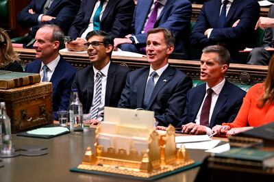 In this image made available by UK Parliament, Prime Minister Rishi Sunak, center left, and Chancellor of the Exchequer Jeremy Hunt, center right, after he delivered his autumn statement to lawmakers in the House of Commons, London, Thursday Nov.  17, 2022.  (Jessica Taylor / UK Parliament via AP)