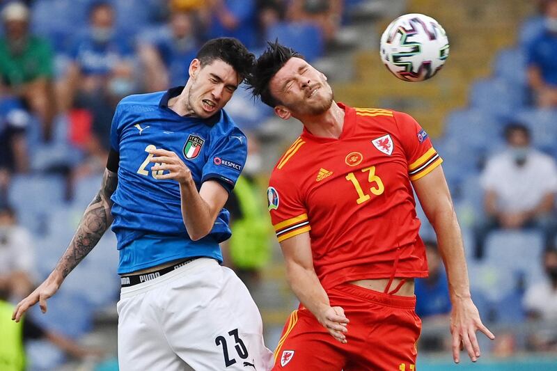 Italy defender Alessandro Bastoni battles for a header with Wales attacker Kieffer Moore. AFP