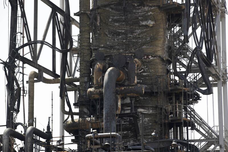 Charred pipework sits on a processing unit at Saudi Aramco's Khurais oil field plant. Bloomberg