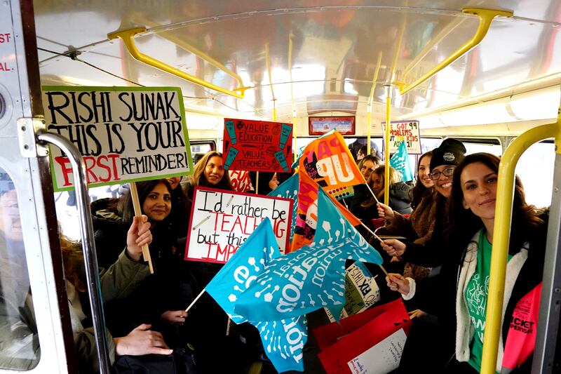 Striking teachers on board a bus travelling to central London. PA