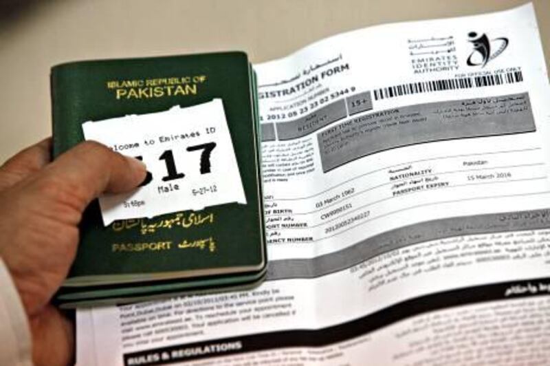 DUBAI, UNITED ARAB EMIRATES - May 27, 2012 - A Pakistani holds his passport and registration form while waiting to be fingerprinted and photographed for his Emirates ID card at the Emirates ID Authority in Al Barsha in Dubai City, Dubai, May 27, 2012. Some people had been waiting for an hour to register. (Photo by Jeff Topping/The National) 