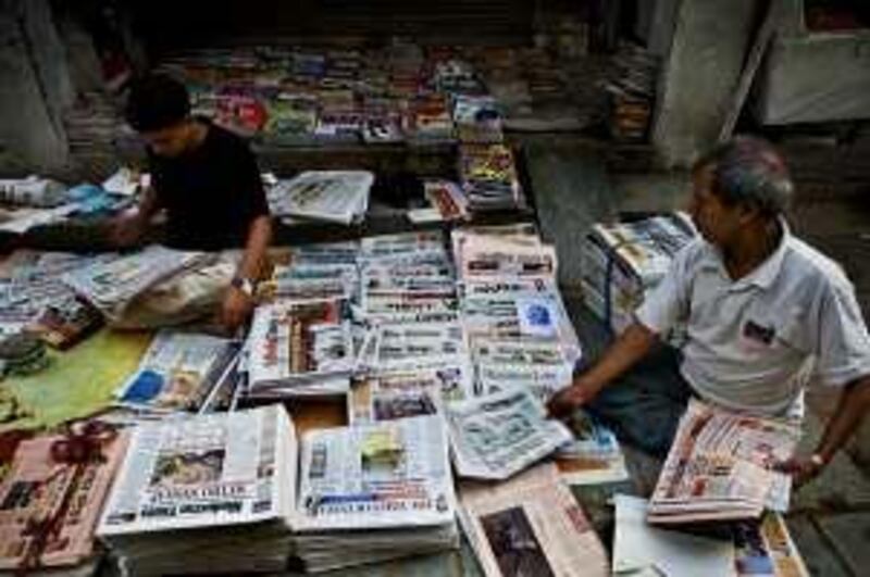 Newspaper sellers sort out and sell newspapers on the road in the Mehar Chand market street early in the morning on 20th October 2008 in New Delhi, India. With internet still out of reach for 95% of the country and literacy higher than ever, more and more are turning to newspapers and magazines.  Photo : Suzanne Lee for The National. *** Local Caption ***  SLee20081020-India_Newspaper-051.jpg