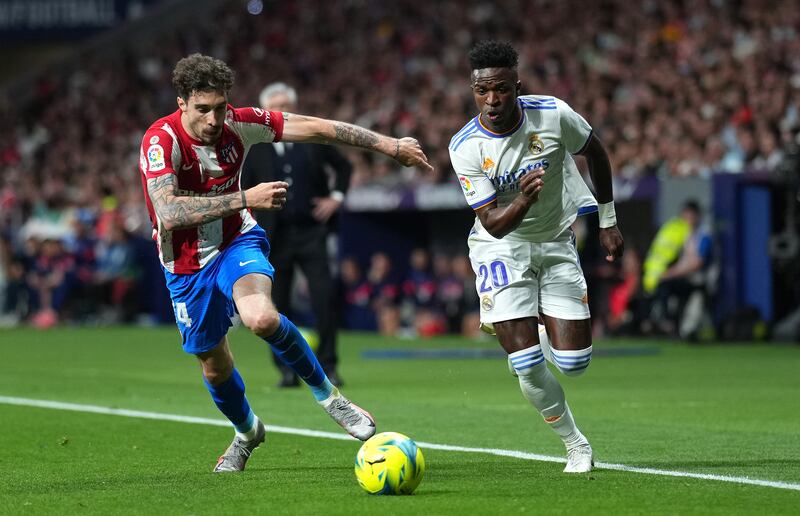 Sime Vrsaljko of Atletico Madrid battles for possession with Vinicius Junior of Real Madrid. Getty Images