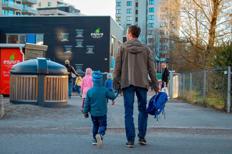 Olav Kneppen delivers his 4-year-old son Oliver to the "Espira Grefsen Station Kindergarten" in Oslo. Norway, which says it has coronavirus under control, started opening up pre-schools after a month-long closure. AFP