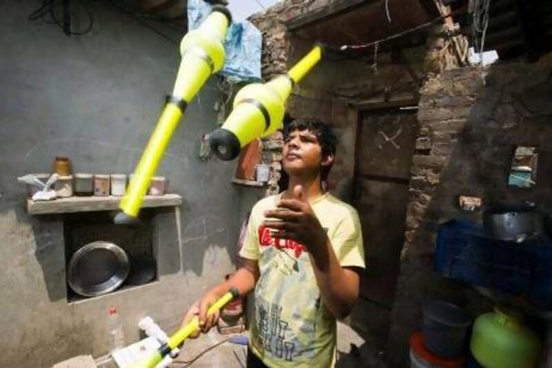 Altimas Khan practises juggling at his home in Kathputli Colony in Delhi. The colony houses more than 2,800 families, who warn that the long and complex process of moving them away may destroy one of the last vibrant communities of India's performance artists.