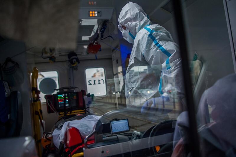 Emergency medical staff of the Mobile Intensive Care Unit of Inter-Europe Ambulance Service Nonprofit Ltd. transport a Covid-19 patient assisted by ventilator from the Military Hospital in Budapest, Hungary. EPA