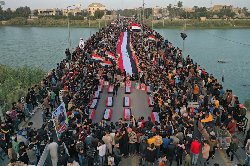 Iraqis march across Zeitoun Bridge in Nasiriyah to honour murdered protesters. Negotiations to form a new government may drag on for weeks or months, jeopardising Iraq’s already fragile political scene and worsening social unrest. AFP