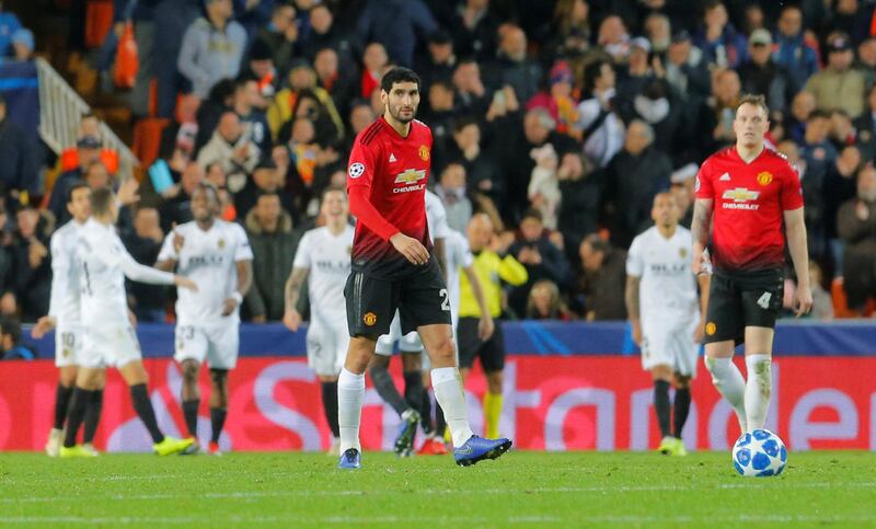 Soccer Football - Champions League - Group Stage - Group H - Valencia v Manchester United - Mestalla, Valencia, Spain - December 12, 2018  Manchester United's Phil Jones (R) reacts after scoring an own goal and the second for Valencia as Manchester United's Marouane Fellaini looks on    REUTERS/Heino Kalis