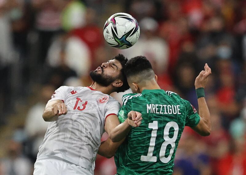 Tunisia's Ferjani Sassi and Houssem Mrezigue of Algeria challenge for a header. Reuters