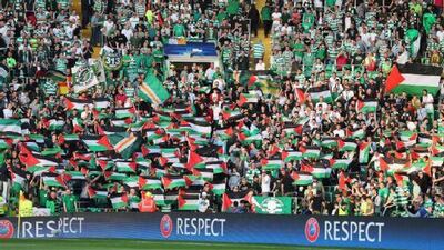 Palestinian flags are waved by Celtic fans during the Uefa Champions League play-off matchagainst Israel's Hapoel Beer-Sheva at Celtic Park on August 17, 2016 in Glasgow, Scotland. Steve Welsh / Getty Images